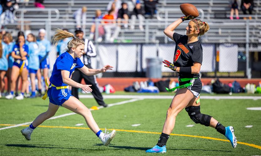 Girls play flag football